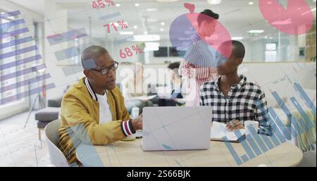 Image of data processing and diagrams over diverse colleagues discussing work and using laptop Stock Photo