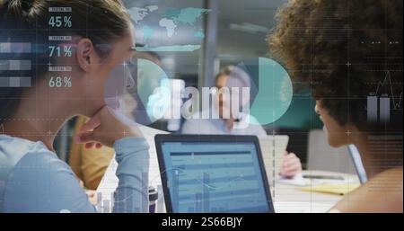 Image of data processing and diagrams over diverse colleagues discussing work with laptop Stock Photo