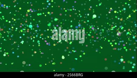 Image of glowing light spots over green background Stock Photo