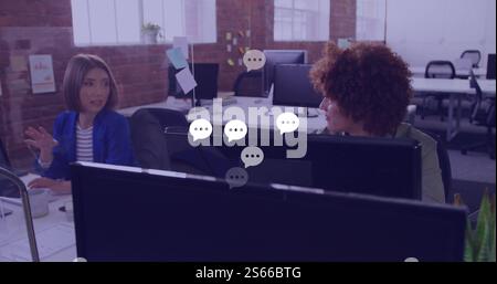 Image of network of speech bubbles over diverse business people in office Stock Photo