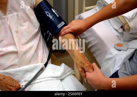 File photo dated 18/01/23 of a nurse taking the blood pressure of an elderly at an NHS hospital in England. Patients are dying in corridors and sometimes going undiscovered for hours, while sick people are being left to soil themselves, according to a damning report into the state of the NHS. The Royal College of Nursing (RCN) published new findings into what is going on in England's hospitals as staff try to manage the number of people needing care. Issue date: Friday June 16, 2006. Stock Photo