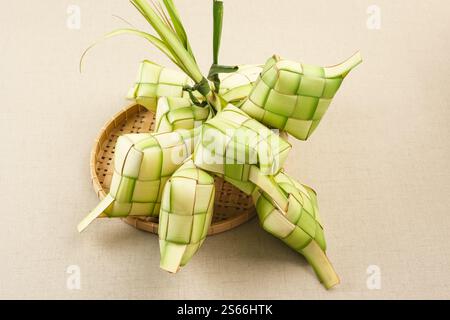 Ketupat or rice dumpling, natural rice casing made from young coconut leaves for cooking rice. Popular during Eid al-Fitr in Indonesia. Stock Photo