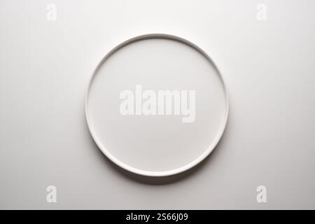 Top view of empty ceramic white plate on white background Stock Photo