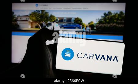 In this photo illustration, the Carvana company logo is seen displayed ...