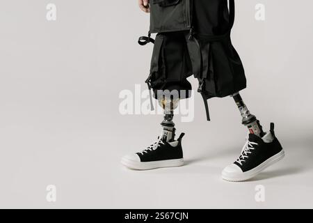 A Man with a prosthetic leg Sitting on Stool Stock Photo