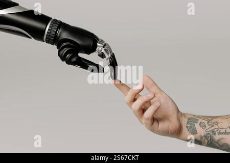man and bionic arm a robot hand touching a mans hand Stock Photo