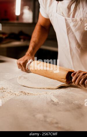 Man Hands Rolling Dough for Pizza Stock Photo