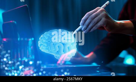 Hand using a stylus to interact with glowing holographic brain model, representing neuroscience research and technological innovation. Stock Photo