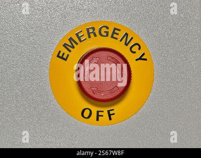 Red Emergency Off button dial on machine shutdown safety mechanism warning switch. Stock Photo
