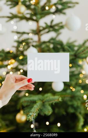Close-Up Photo of Person Holding a blank Christmas Card Stock Photo