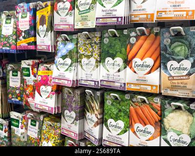 Gardening supplies display in store featuring various seed packets Stock Photo