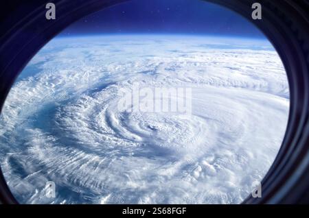 Earth in international space station porthole. Hurricane over planet Earth. Storm, hurricane, typhoon. Elements of this image furnished by NASA. Stock Photo