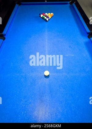 Pool table set up for a game with balls arranged in triangle formation Stock Photo