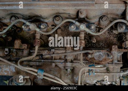 A detailed image of an aged, rusty engine block showcasing fuel lines ...