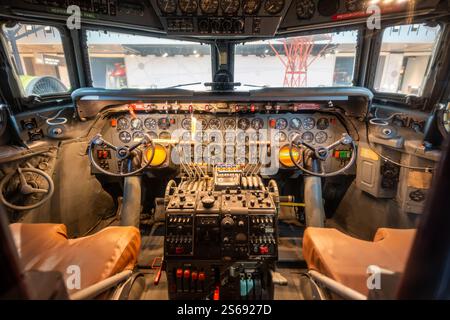 Smithsonian Air and Space Museum National Mall | WASHINGTON D.C., United States — The cockpit of a Douglas DC-7 sits open to view in the America by Air exhibit at the National Air and Space Museum, its dials and dual control yokes preserved from American Airlines service. The DC-7, built in the 1950s, was among the last piston-engine airliners before jets took over long-haul commercial routes. Stock Photo