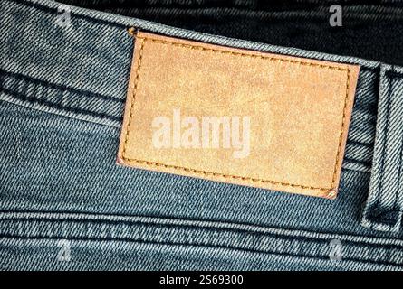 Denim jeans with blank label close up on fabric texture. High quality photo Stock Photo