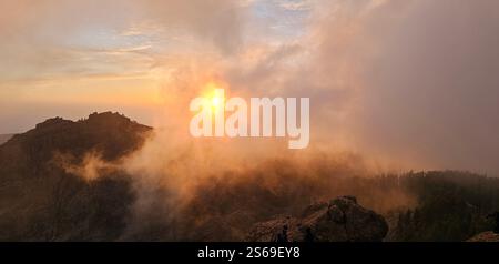Lost in the fog, where the sun gently kisses the mountains and nature speaks in whispers. Stock Photo