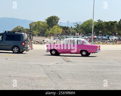 Pink panther vintage car going to the 21th Summer Classic Car Rally at Istiea Aidipsos in Greece Stock Photo