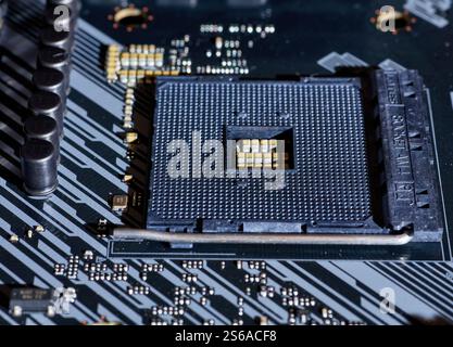 A close-up view of an AM4 CPU socket on a motherboard. This detailed image shows the precision of the socket pins and the structure, perfect for hardw Stock Photo