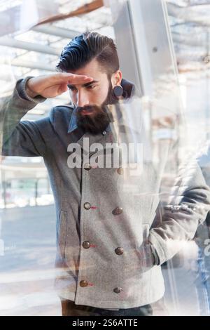 businessman looking through window Stock Photo