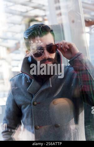 businessman looking through window Stock Photo