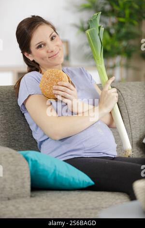 pregnant woman with burger and a leak Stock Photo - Alamy