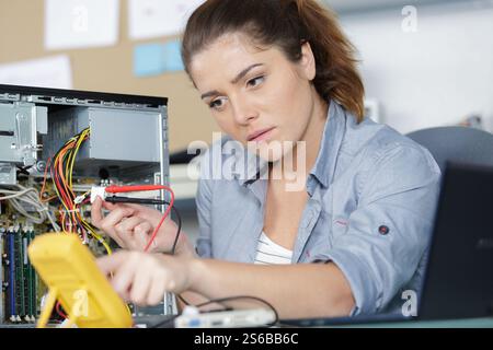 female technician using voltage meter Stock Photo