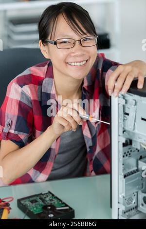 female computer engineer working on tower computer Stock Photo