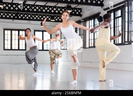 Four dancers exercising swing movements Stock Photo