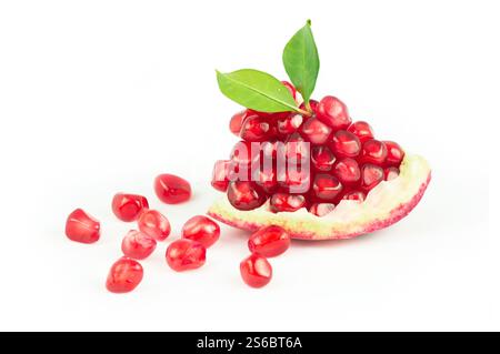 Fresh ripe whole and split juicy pomegranate with seeds and leaves isolated on white background, healthy red fruits concept (Punica granatum) Stock Photo