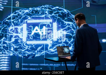 Startup employee looking over lines of code, using AI software to take data driven decisions in tech industry. IT specialist developing innovative artificial intelligence solutions for company Stock Photo