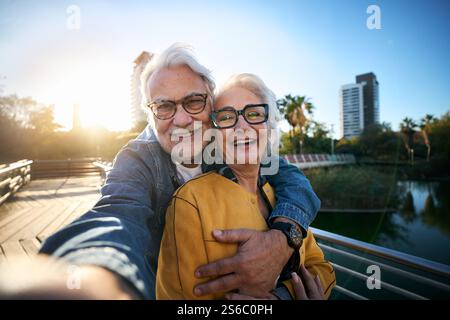 Portrait happy senior tourist couple taking selfie outdoors in historical city. Photo mobile phone. Stock Photo