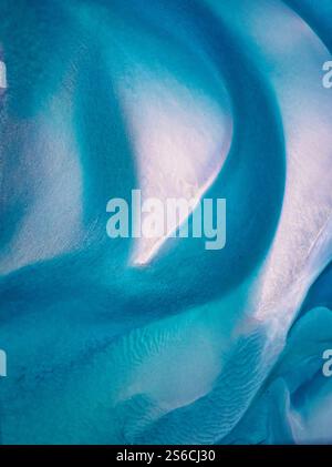 Aerial view of stunning patterns created by the interplay of ocean waves and sandy textures along the coast of Iceland Stock Photo