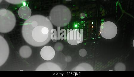 Image of glowing light spots over computer servers Stock Photo