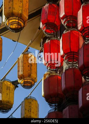 Dali, China - November 19, 2024 : Vibrant red and gold lanterns hang against a clear blue sky, creating a festive and celebratory atmosphere.  The lan Stock Photo