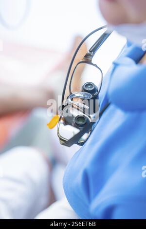 Close-up of medical magnifying glasses worn over a blue gown, dental practice, Germany, Europe Stock Photo