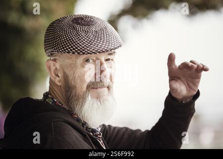 An image of an old man with a beard outdoor Stock Photo