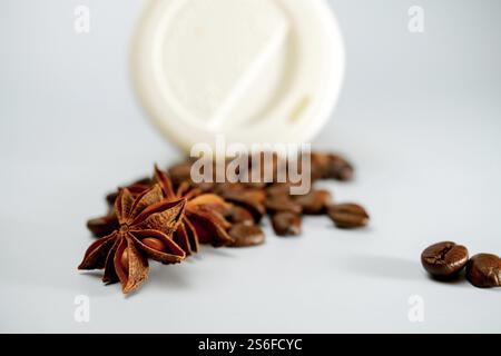 Cardboard coffee cup with coffee beans and star anise isolated on white background and copy space Stock Photo