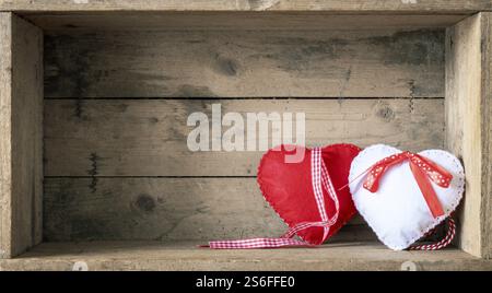 An image of two felt hearts on a wooden background Stock Photo