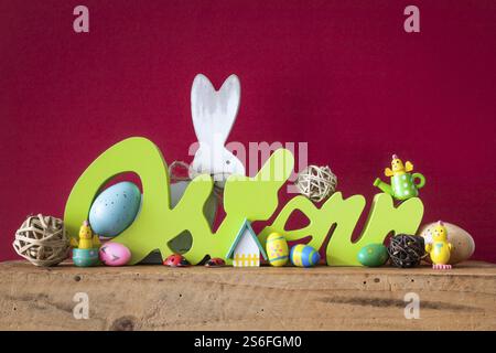 The word Easter in german language with easter bunny eggs and chicks Stock Photo
