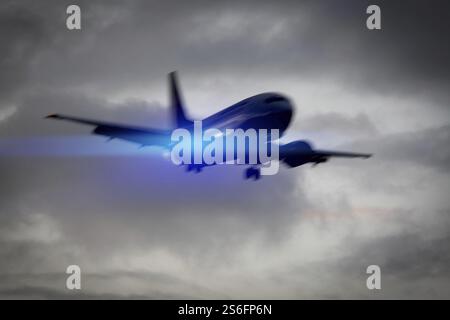 An image of a plane in the sky motion blur with blue light flare Stock Photo