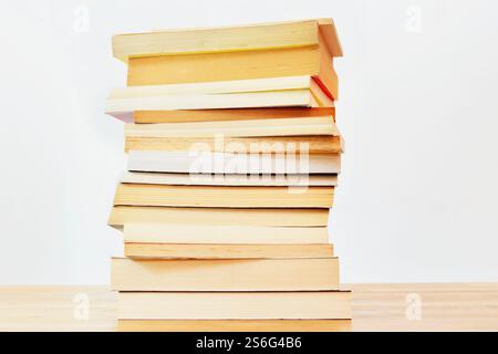 One  stack of different books on a wooden table , books used and new , Stock Photo