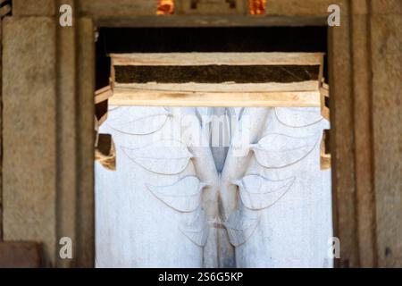Detail of ornate carvings of leaves on an ancient statue in Shravanabelagola in Karnataka, India. Stock Photo