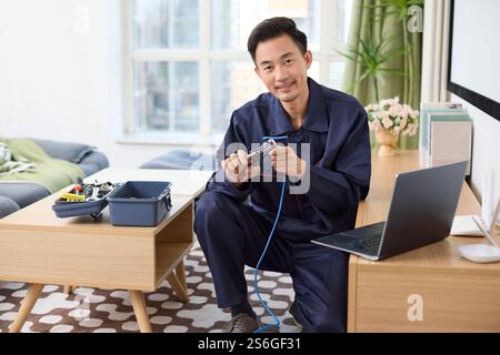 IT technician fixing internet cable Stock Photo