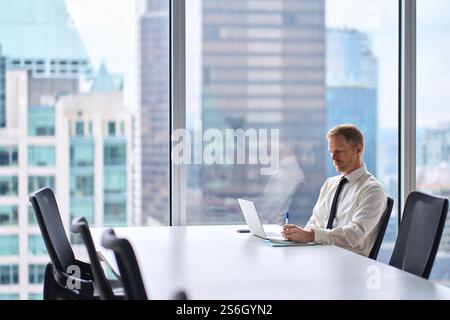 Busy businessman financial analyst or manager using computer at work. Stock Photo