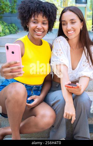 Happy friends taking a fun selfie outdoors.Vertical Stock Photo