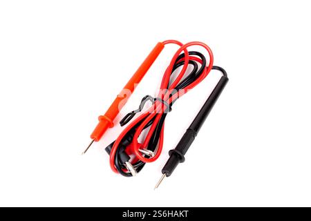 Close-up view of digital multimeter test leads with red and black probes, arranged neatly on a white background with copy space. Stock Photo