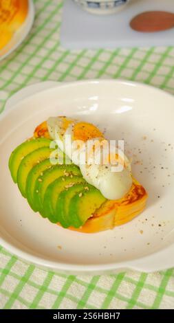 Healthy toasts for breakfast with avocado and boiled egg. Stock Photo