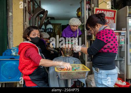 A beauty or hairdressing salon in a street of the old quarter of Hanoi in Vietnam Asia Stock Photo