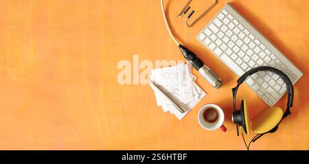 Music or podcast concept with stylish headphones,vintage microphone,books and computer keyboard on red table, top view,flat lay with copy space. Stock Photo